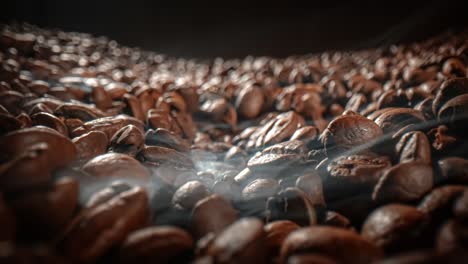 Close-up-of-seeds-of-coffee.-Fragrant-coffee-beans-are-roasted-smoke-comes-from-coffee-beans.