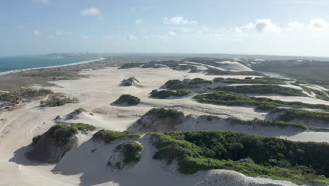 aerial - beautiful sandy dunes on genipabu beach, brazil, lowering shot