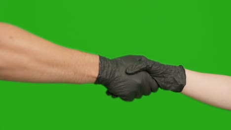 handshake of man and woman in rubber medical gloves, chroma key