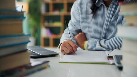a person studying with books and a laptop
