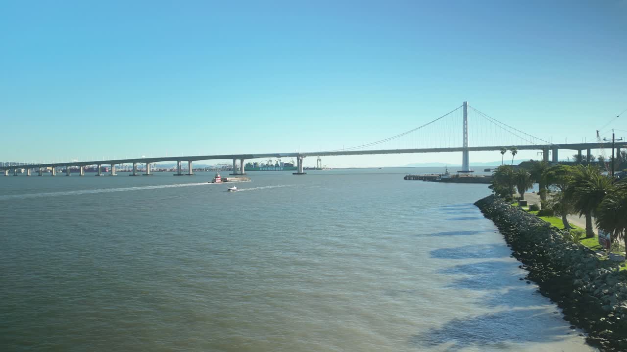 Establishing drone shot of San Francisco-Oakland Bay Bridge to Treasure Island in the day in California, USA