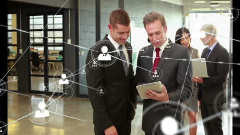 network of connections animation over business people using tablet in office