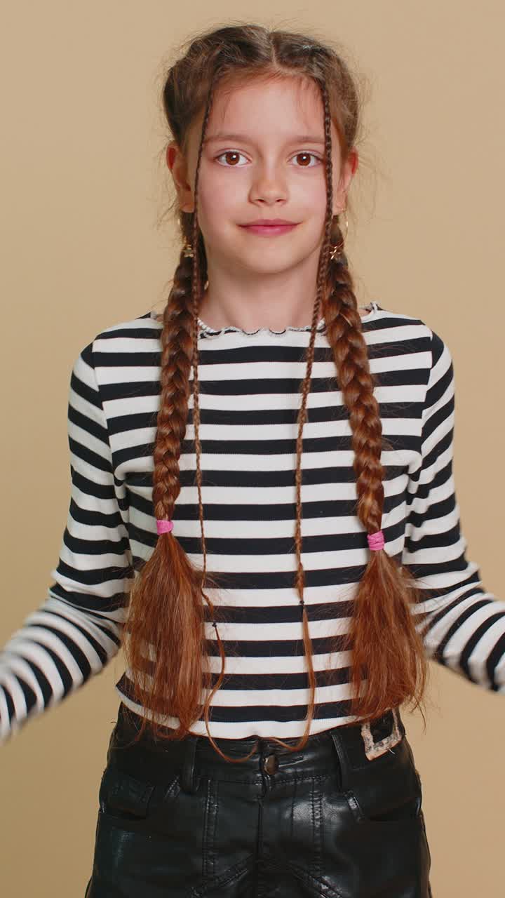 Happy child girl kid listening music dancing disco having fun relaxing on party making funny moves