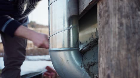 Man-Building-DIY-Hot-Tub-Sealing-The-Gaps-Behind-The-Chimney-With-Mortar-Paste