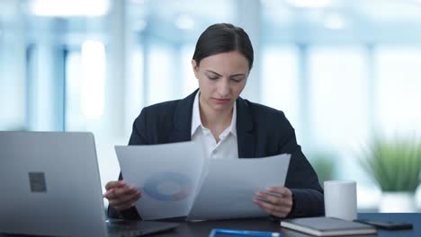 confused indian business woman signing a contract