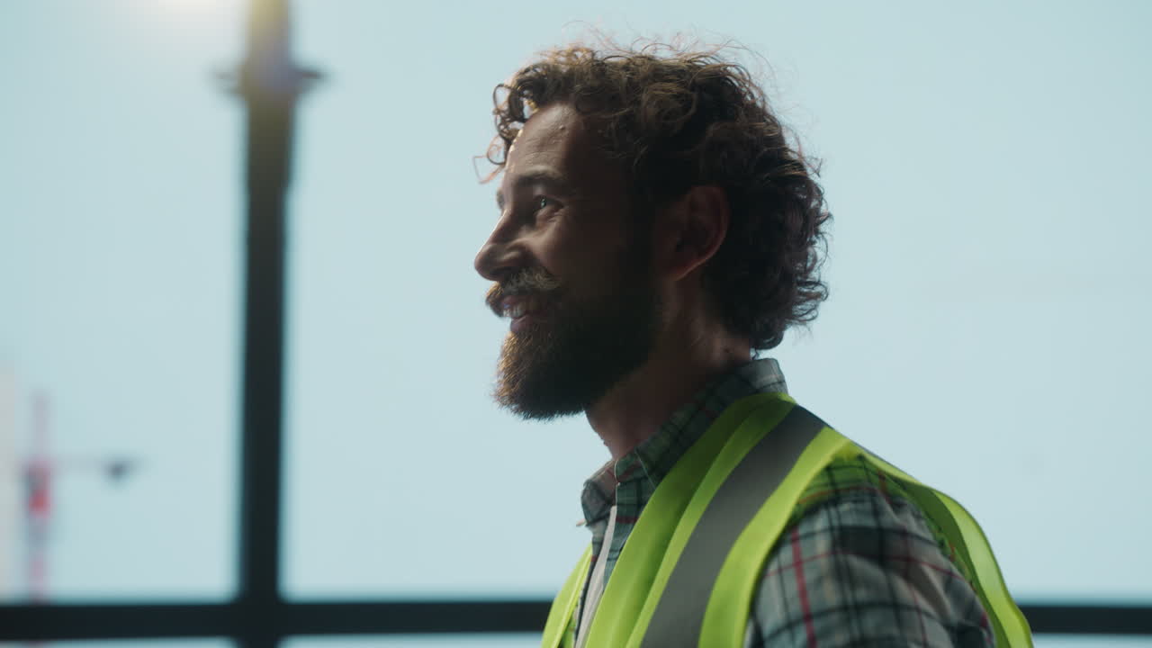 A construction worker or engineer overlooking a building site