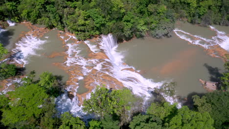 wide rotating drone shot of the cascadas de agua azul and the surrounding forest found on the xanil river in chiapas mexico