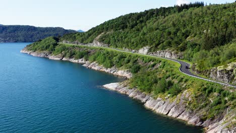 aerial view of a vehicle driving on the norwegian scenic route helgelandskysten