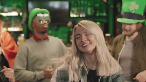 cheerful people dancing in irish pub