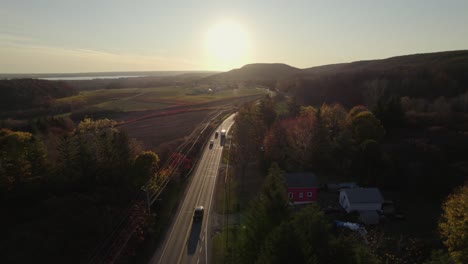 long suburban road leading to sun setting