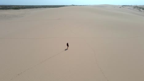 walking alone desert remote arid sand dunes colombia dry landscape la guajira aerial