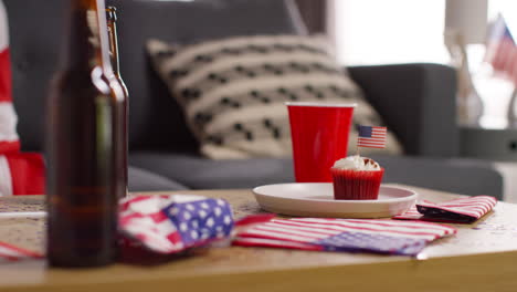 Close-Up-Of-Cupcakes-With-American-Stars-And-Stripes-Flags-And-Bottles-Of-Beer-At-Party-Celebrating-4th-July-Independence-Day-1