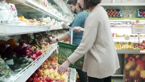 people choosing vegetables in grocery store