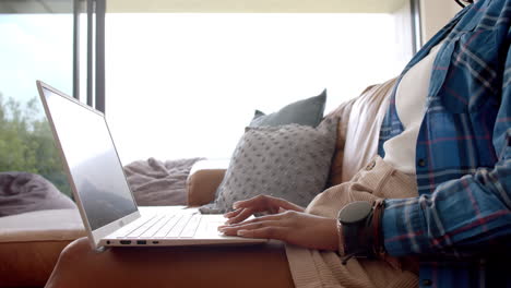 a young african american female professional/student typing on laptop