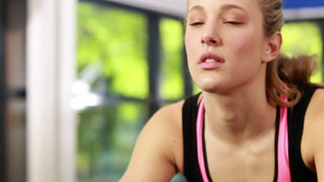fit woman using exercise bike