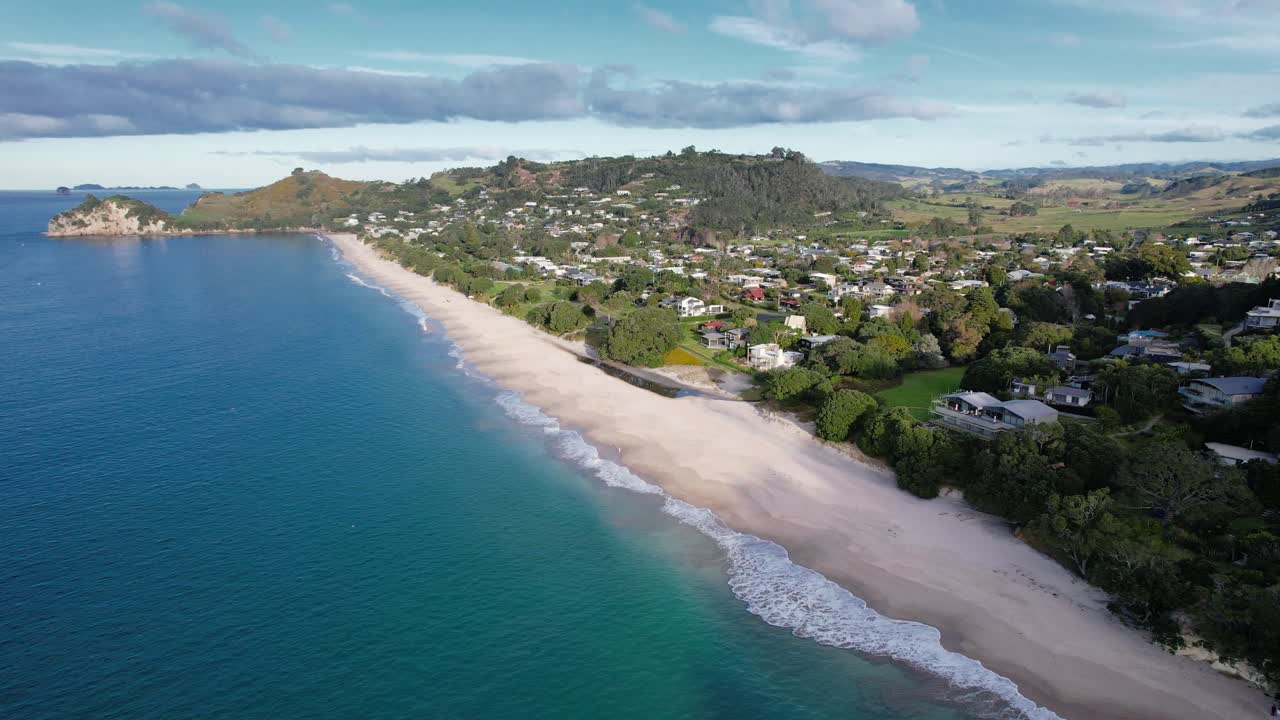 Aerial View of a Scenic Coastal Town with a Long Sandy Beach