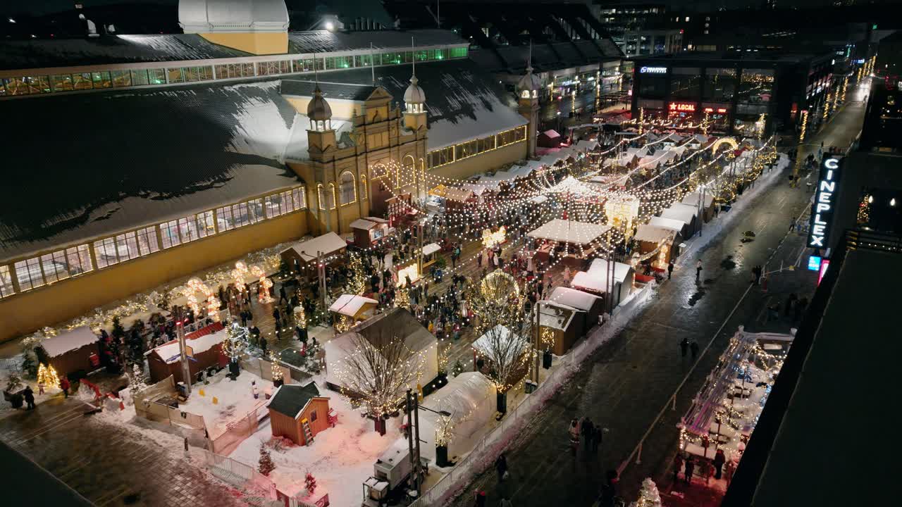 Aerial Overlooking Illuminated Lansdowne Christmas Market At Night Beside Aberdeen Pavilion In Ottawa. Slow Pan Right