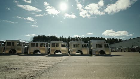 array of unfinished fire trucks under the bright sun,industrial assembly and emergency vehicle production