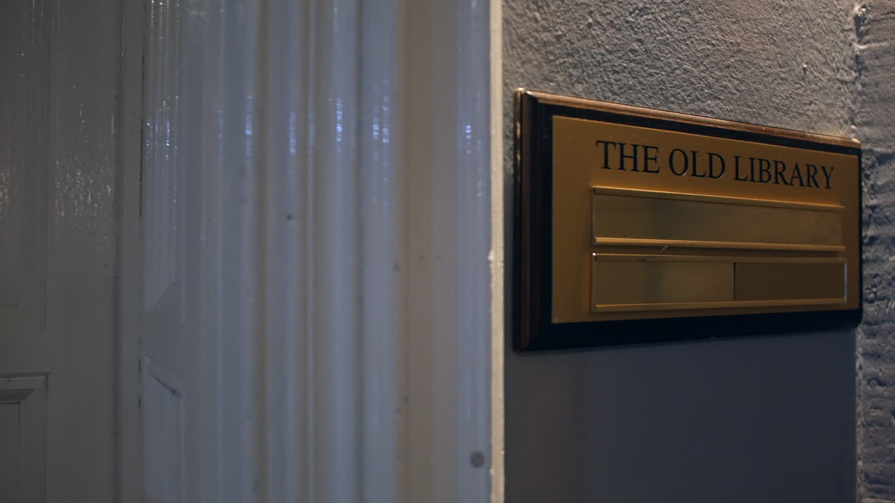 The Old Library sign in a manor house hotel outside a door