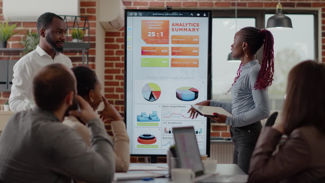 African american people receiving applause from colleagues at business meeting