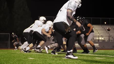 a football player jumps over his opponent and makes a touchdown