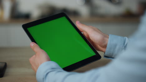 hands holding mockup tablet close up. guy touching green screen swiping zooming.