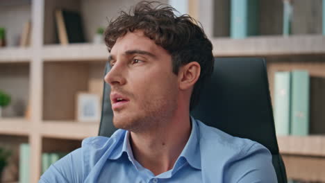 tired manager massaging neck in office closeup. pensive man overwork suffer pain