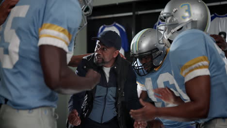 football team and coach in locker room