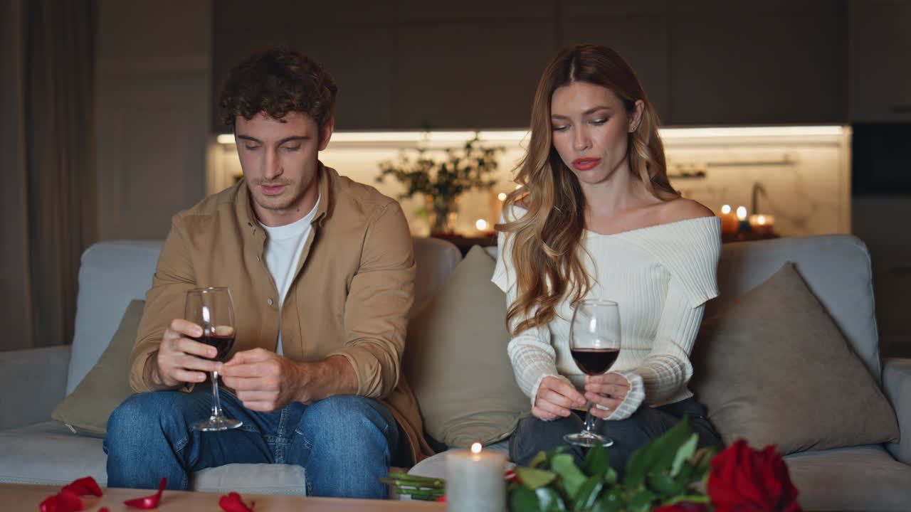 Pair talking romantic date on home couch closeup. Two shying people sitting sofa