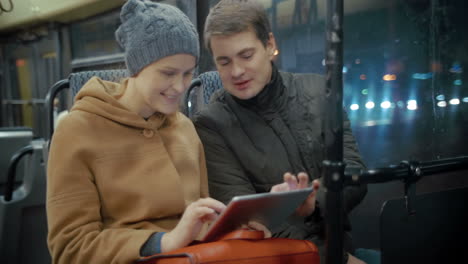 friends with tablet riding a bus