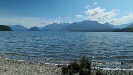 serene lake manapouri surrounded by distant mountains, a tranquil vista in the heart of nature