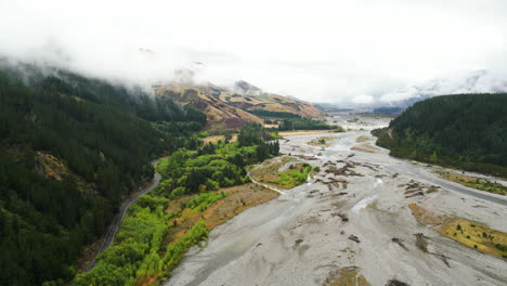 Scenic-road-on-river-bank-in-Wairau-valley,-New-Zealand-on-cloudy-day-after-rain