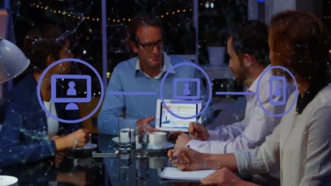 animation of network of digital icons against diverse businesspeople discussing together at office