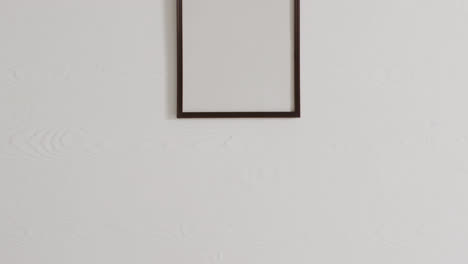 black frame with copy space on white background against white wall