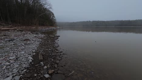 The-beginning-of-a-massive-snowstorm-on-the-rocky-shore-of-a-pristine-and-beautiful-mountain-lake