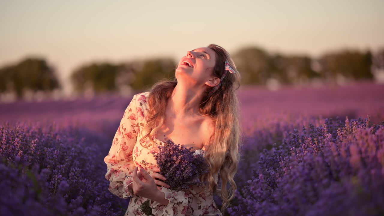 Peaceful woman sitting in lavender rows, touching blossoms with a calm smile
