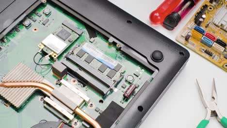 computer engineer installing ddr ram memory into slot, laptop upgrades