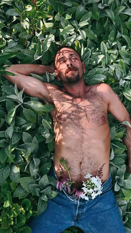 man relaxing in a garden with flowers