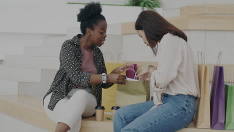 two women shopping and sharing their purchases