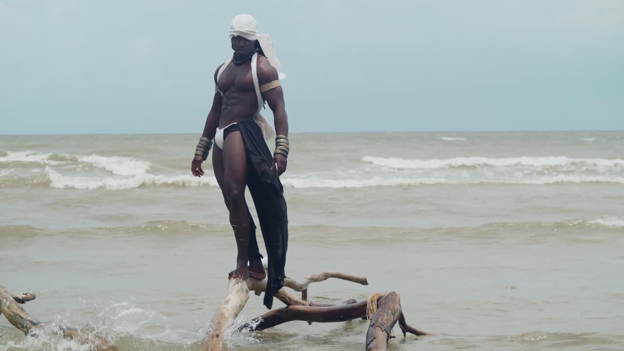 A dark-skinned male cosplayer with muscles on the beach.