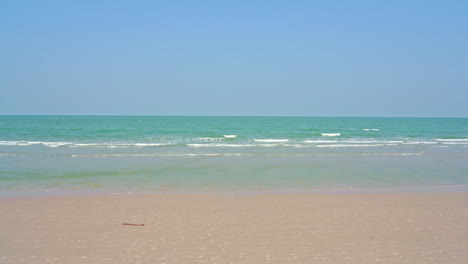 Tropical beach with deep blue sea and skyscape view. Soft waves on the beach
