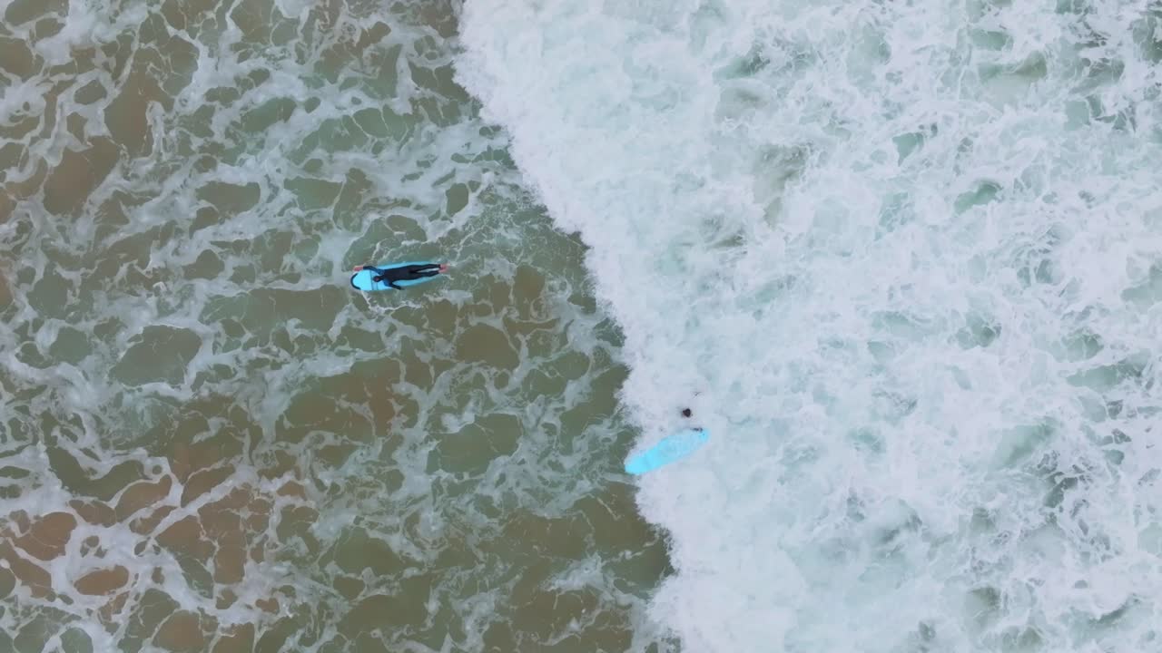 초보 서퍼 들 은 격렬 한 바다 에서 파도 에  ⁇ 싸여 새 의 눈 으로 볼 수 있다