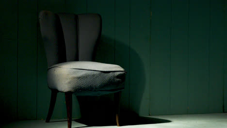 an old green chair in an empty green room