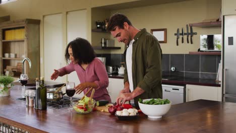 pareja feliz preparando comida juntos en la cocina, cortando verduras para ensalada