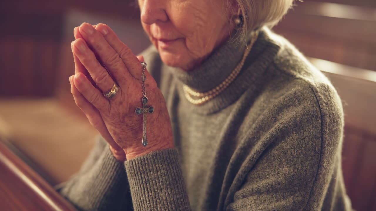 Hands, praying and senior woman in church