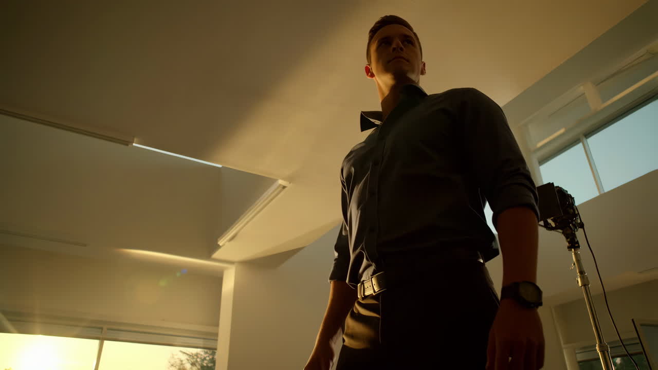 Confident Man in Formal Wear in a Backlit Indoor Setting