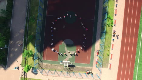 aerial view of school lesson on sport playground