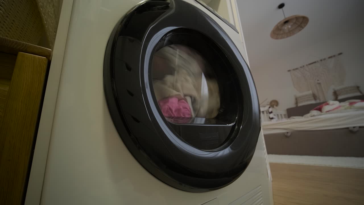 Close-up of Washing Machine Drum Tumbling Clothes