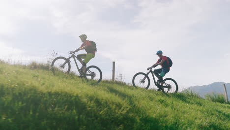 Two men mountain biking uphill