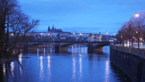 Vista-Lejana-De-La-Hora-Azul-Del-Castillo-De-Praga-Con-Puente-En-Primer-Plano-Durante-La-Madrugada